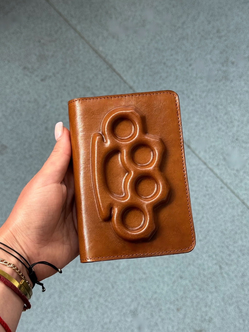 Passport cover with a brass knuckles in brown image 0